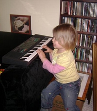 Little Girl Playing a keyboard